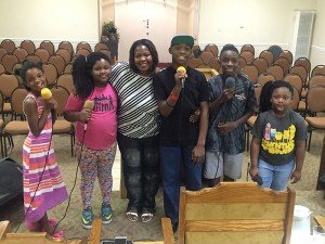 Shanjula Harris with children at church where she leads the choir practice. “Engaging with the youth brings me such joy; witnessing their eagerness to express their faith uplifts my spirit. I cherish our community and church family. My deepest gratitude goes to my Pastor, whose support sustains me. I feel truly blessed!”