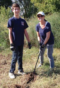 Melissa Chaiken with son, Spencer, 15, engaged in volunteer work at Plano Community Garden with the YMSL Silver Star Chapter.