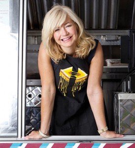 Ashlee Kleinert serving food from Ruthie’s Food Truck, a venture she and Chris founded in 2011 that provides delicious meals while donating a portion of profits to nonprofits.