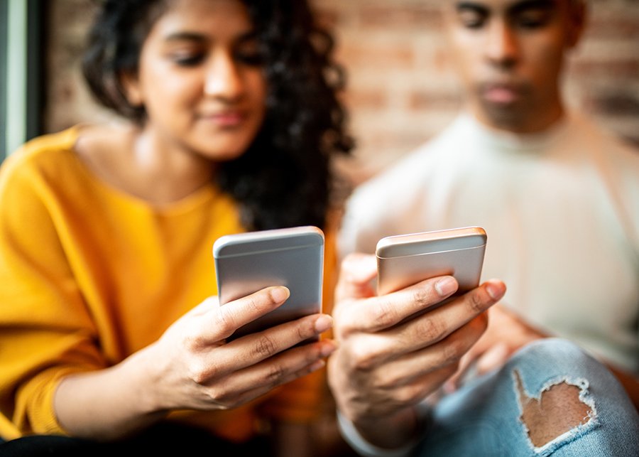 teenagers looking at their phone